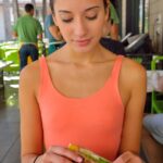 Adorable skinny teen Roxanna flashes her trimmed vagina in public