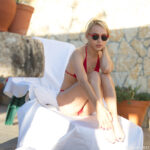 Blonde sweetie Chloe removes her bikini and rubs her tasty vagina