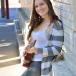 Bosomy babe Summer exposes her big ass while playing a small guitar in public