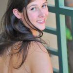 Brunette girl with lovely boobs Miley strips and fists her love hole
