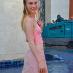 Slim 18 year old Sharlotte flashes her naked pussy in public places