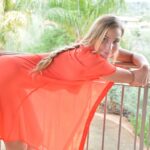 Solo girl slips off her long and quite see thru shirt out on the balcony