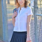 Thin teen shows off her upskirt panties in her schoolgirl uniform on sidewalk
