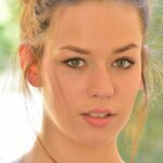 Beautiful brunette female shows off her naked body in public parking lot