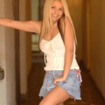 Golden-haired babe Sandy unveils her big tits and pussy in public