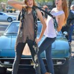 Two frisky teenage babes Raylene & Romi strip in public & pose nude