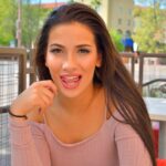 Sensual brunette Olivia hikes her dress up and toys her anal hole in public