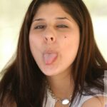 Babe Sara poses pantyless in a sexy skirt & shows her ass & pussy outdoors