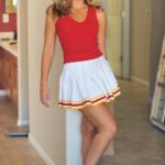 Lovely cheerleader Pamela fingers & toys her sweet shaved pussy