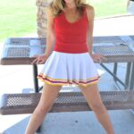 Lovely cheerleader Pamela fingers & toys her sweet shaved pussy