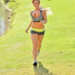 Shorts clad jogger bares all to fill her pussy from the hose after a hot run