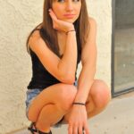 Skinny cutie Risi flashes her twat and displays it outdoors in a solo