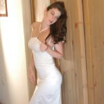 Angelic babe Kyla flashes her juicy tits & a pantyless upskirt in a white gown