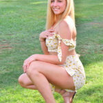 Blonde amateur exposes her firm boobs during a walk in the park