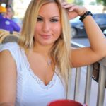 Busty amateur with big tits strips outdoors to fondle her pierced pussy