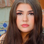 Long-haired glamour babe Aria flashing a pantyless upskirt in public
