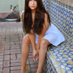 Long-haired glamour babe Aria flashing a pantyless upskirt in public