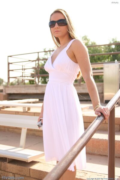 Blonde babe Viktoria doffs her white dress and toys herself in the park Image #8