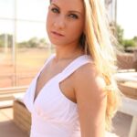 Blonde babe Viktoria doffs her white dress and toys herself in the park