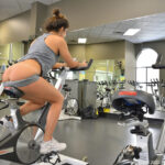 Cute brunette Natalie exercises before a cucumber insertion in public