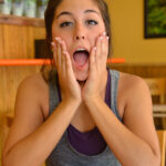 Cute brunette Natalie exercises before a cucumber insertion in public