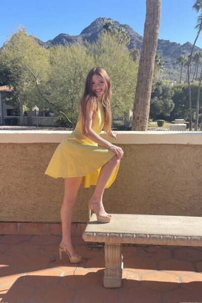 First timer flashes her naked body underneath clear skies in a yellow dress Image #15