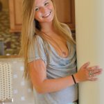 Fully clothed sweetie pulls down jeans on lawn before masturbating inside