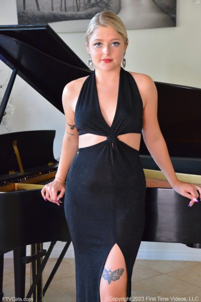 Sexy blonde Jill masturbates with a white dildo while sitting at the piano Image #1