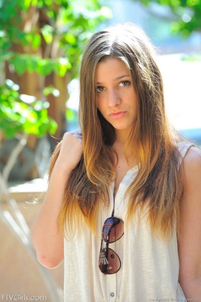 Naughty teen girl takes off her clothes on sidewalk outside her house Image #1