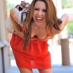 Babe in a red dress Lola flashes her cunt downtown before masturbating at home