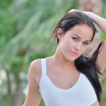 Lovely raven-haired babe spreads her pussy lips in a public place