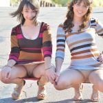 Sweet teens Athena & Mindy flash their asses outdoors before indoor fingering